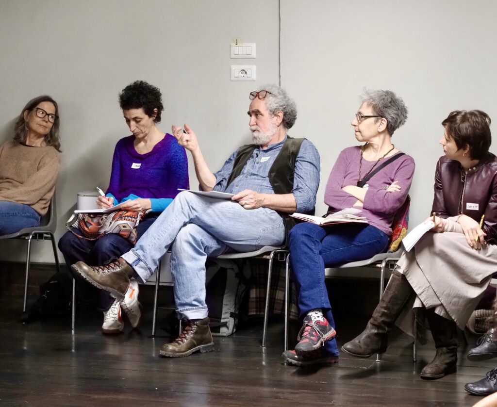 Five people sitting in a workshop setting