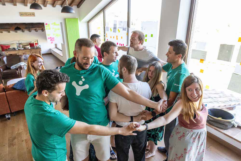 A photograph of the SessionLab team playing Human Knot.