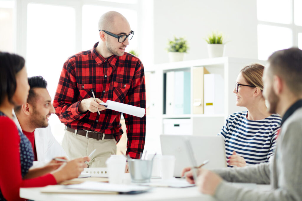 young team leader leading a discussion with colleagues in an office