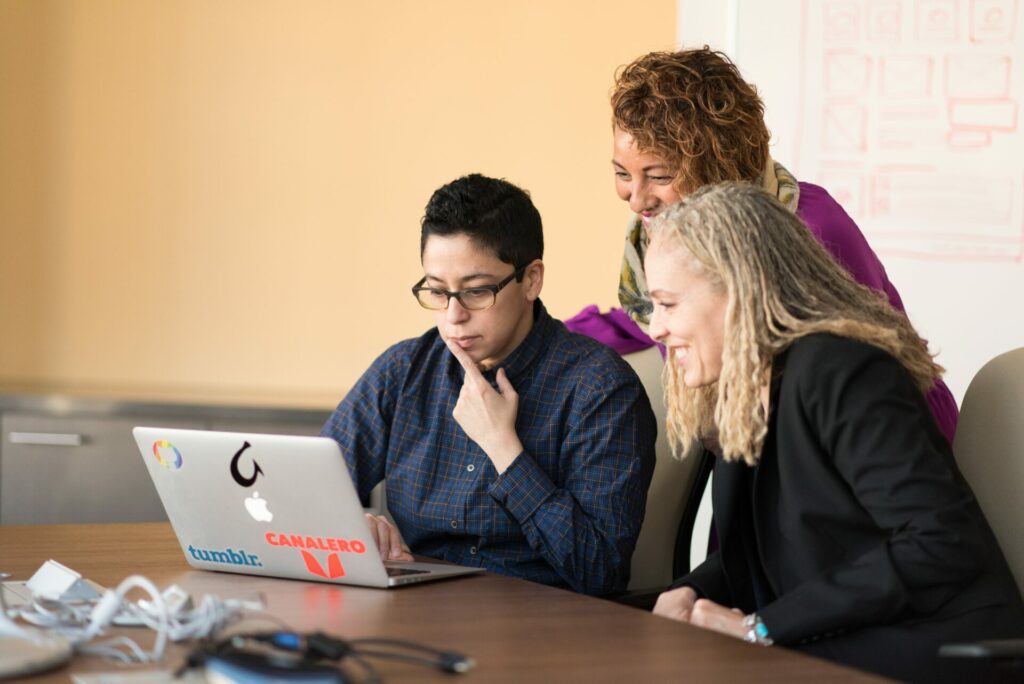 Three colleagues working at a computer