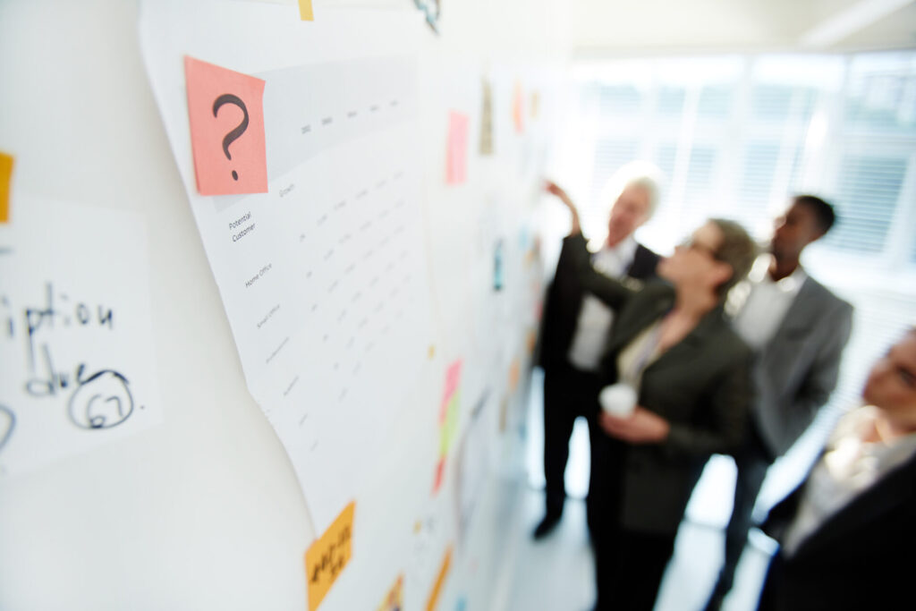 Two office colleagues planning a project at a whiteboard