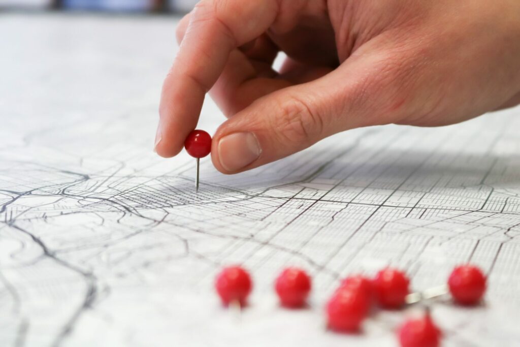 a person placing pins on a map of a city