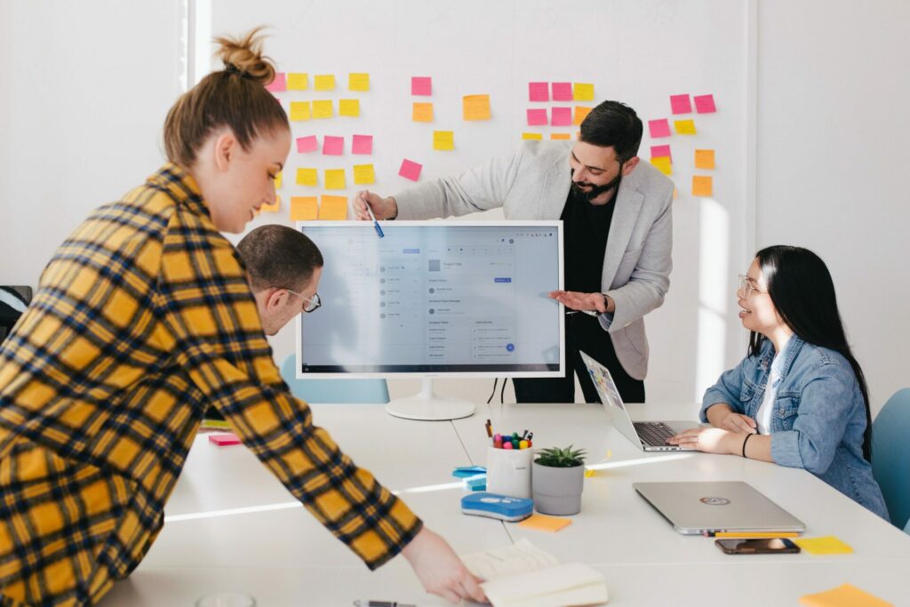 people working around a screen