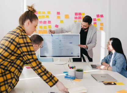 people working around a screen