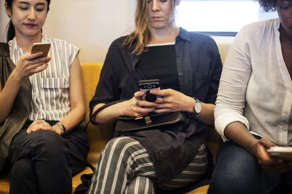 three people working on their phones