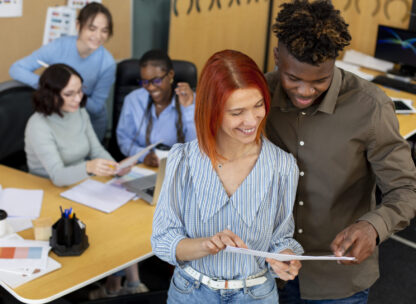 Two colleagues looking at a document together in an office situation
