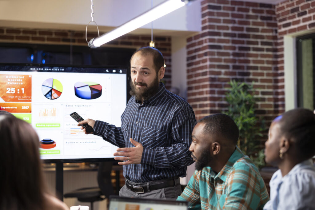 A man giving a presentation in front of colleagues
