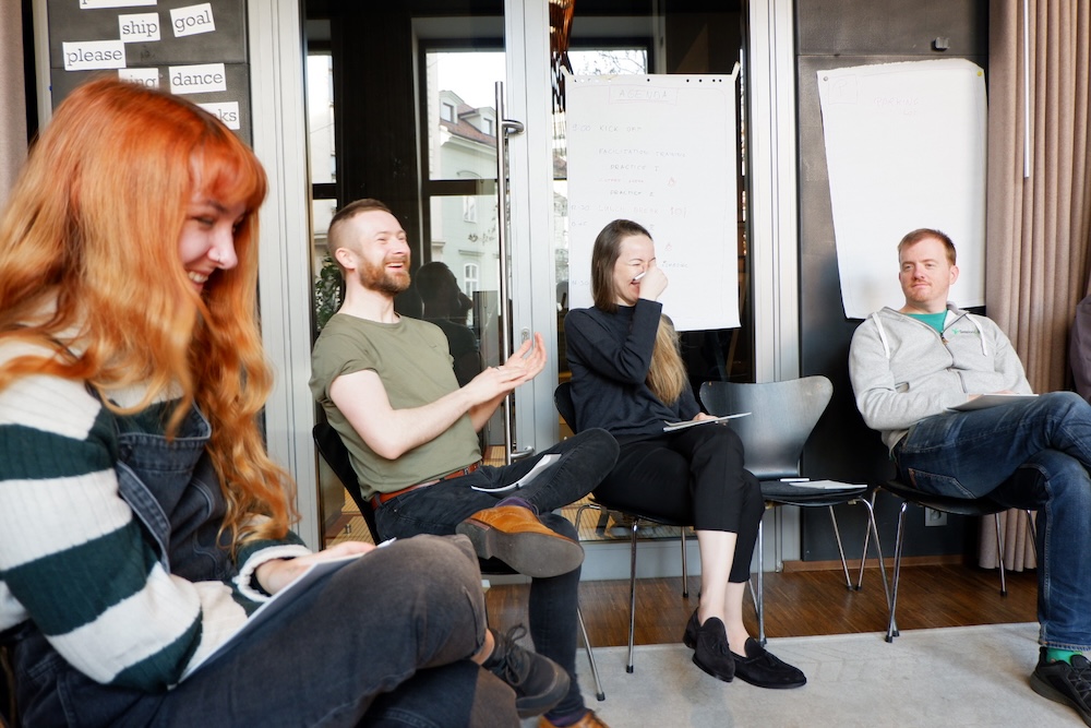 SessionLab team laughing during a meeting reflection
