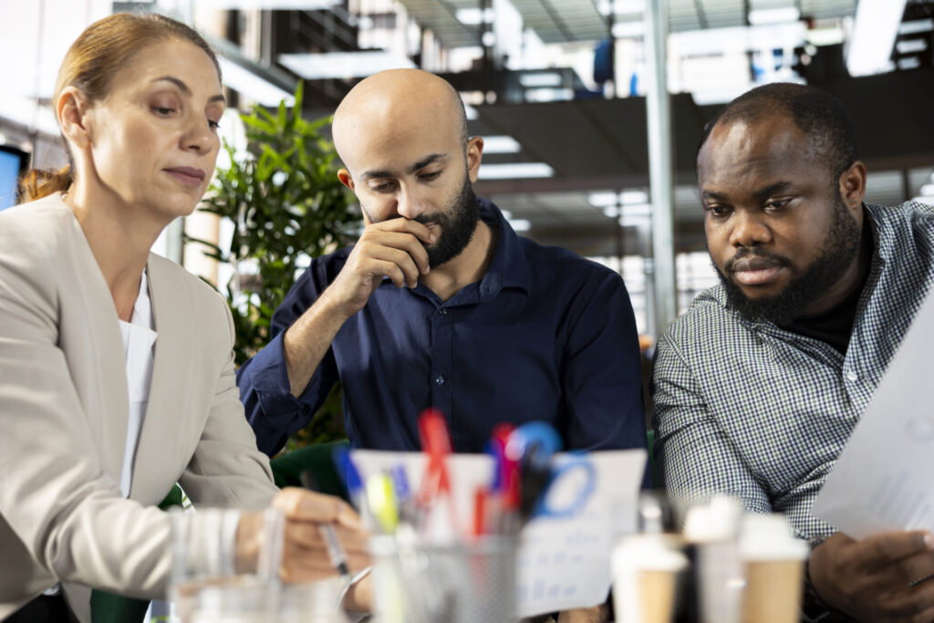 three team members discussing and thinking