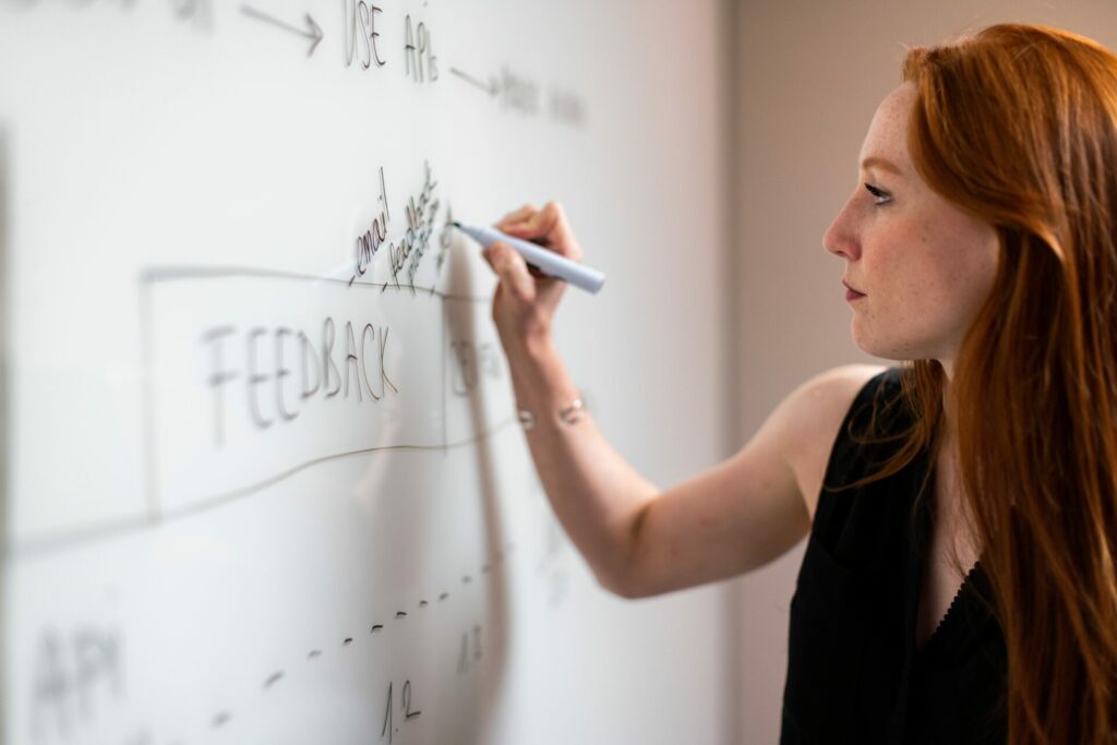 woman writing on a whiteboard